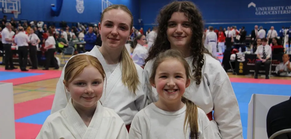 Four junior members of Maesteg Shotokan Karate Club in karate gi at Bryn Community Hall
