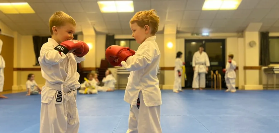Two young Maesteg Shotokan Karate Club students in karate gi during a junior class in Bryn