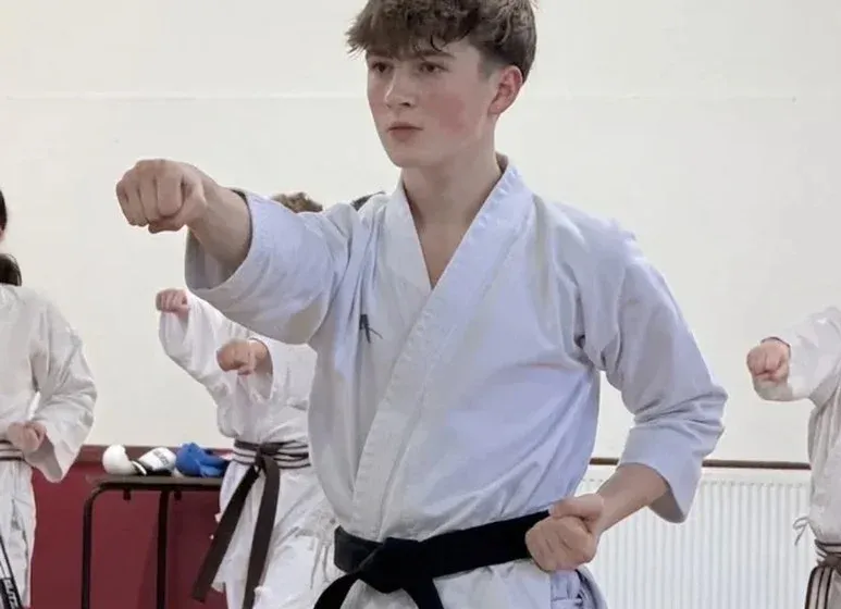 Student practising a Shotokan karate technique during training at Bryn Community Hall